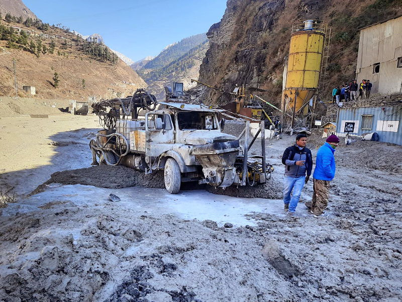 People inspect the site near the damaged Dhauliganga hydropower project at Reni village in Chamoli district after a portion of Nanda Devi glacier broke off in Tapovan area of the northern state of Uttarakhand.